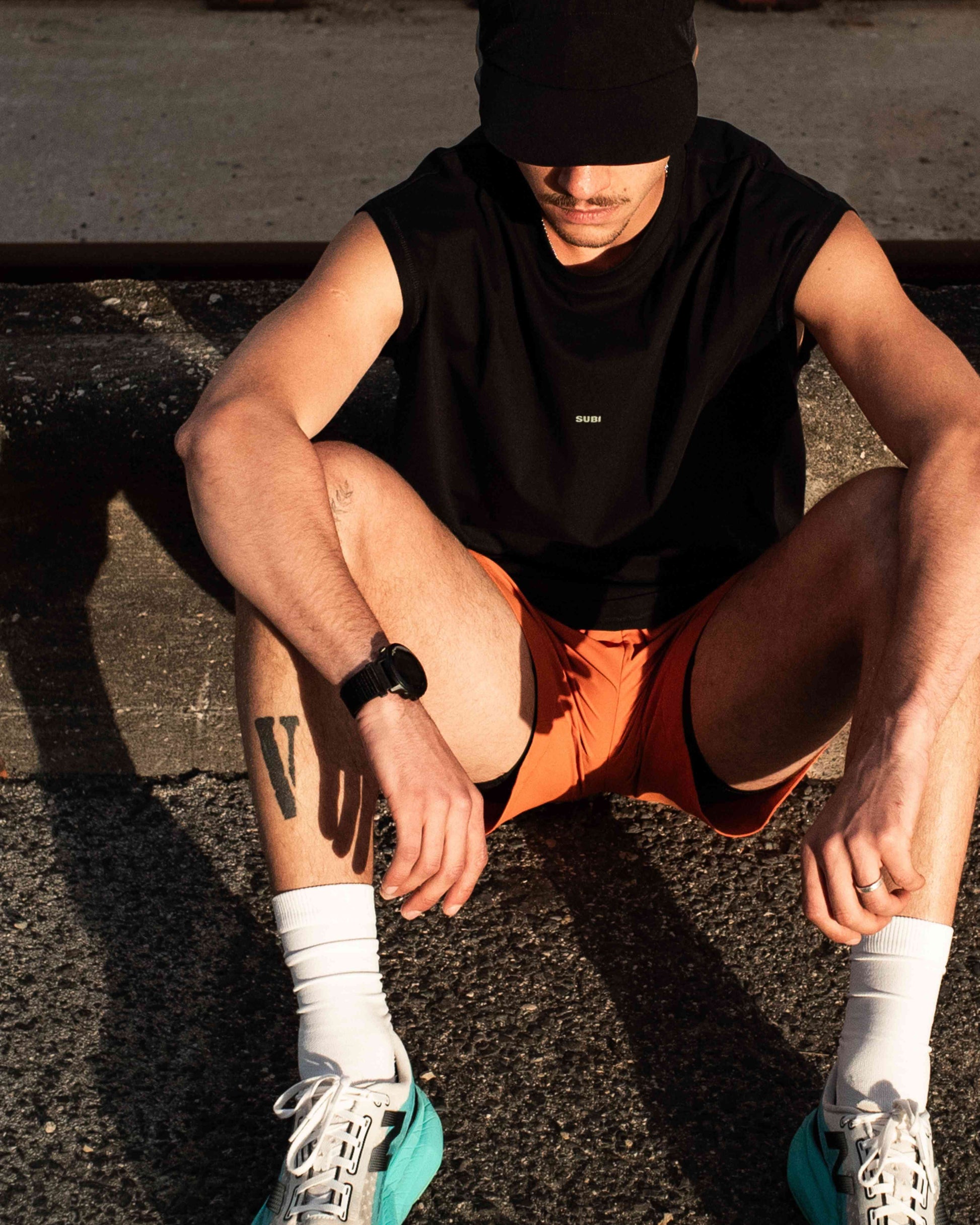 Orange Running shorts, front view, lightweight shell, 4-way stretch, model